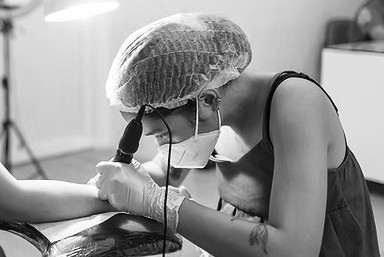 Young Filipina tattoo artist at work