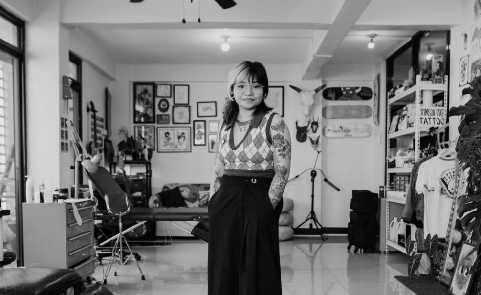 Young Filipina tattoo artist at work