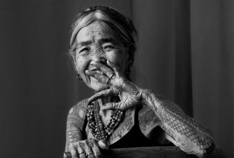 Young Filipina tattoo artist at work